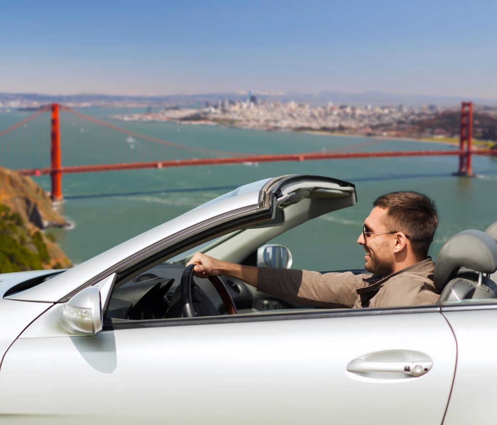 A man navigating San Francisco in his car. 