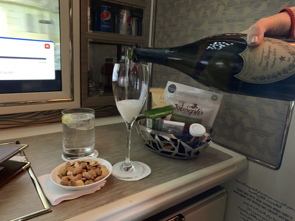 Emirates First class suite B777-300ER champagne pouring 