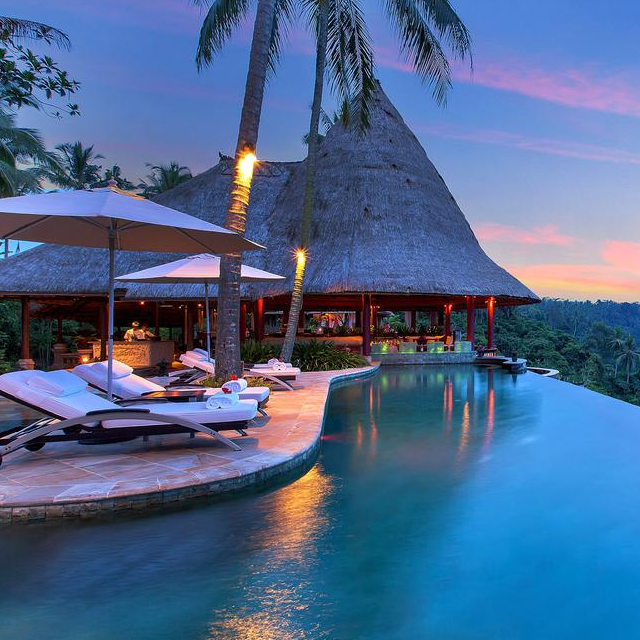 a pool with lounge chairs and umbrellas