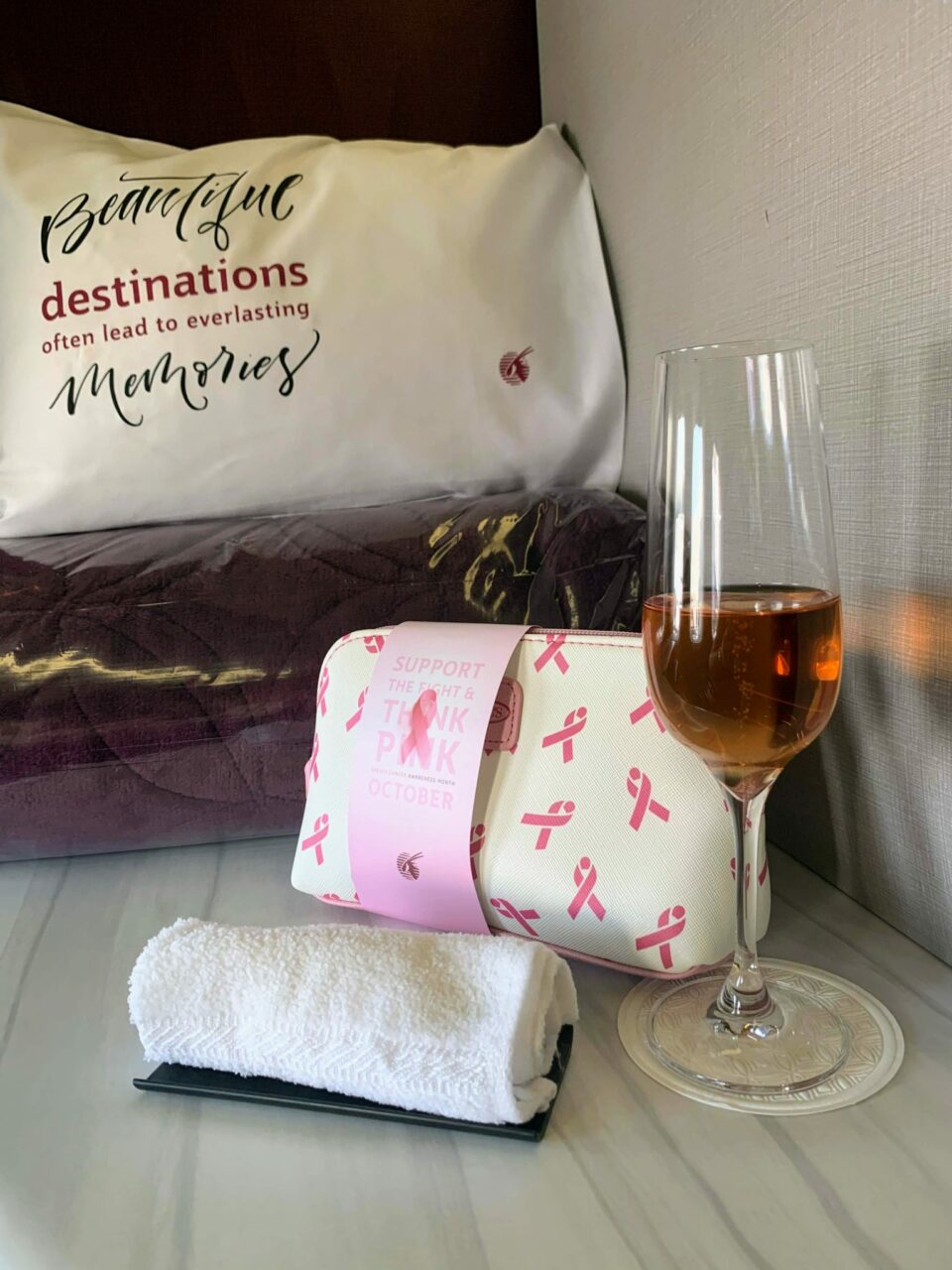 Qatar Airways QSuite B777 Hot towel and champage