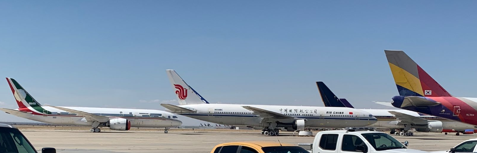 The ex Mexican Presidential Dreamliner is on the far left in red and green, along with 2 x ex Singapore Airlines 777's and an Asiana 747 Freighter