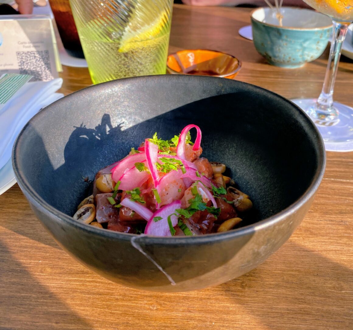 Red Nikkei corvina ceviche with Leche de tigre, red onion, tamarind, fresh ginger, lime, coriander and corn.