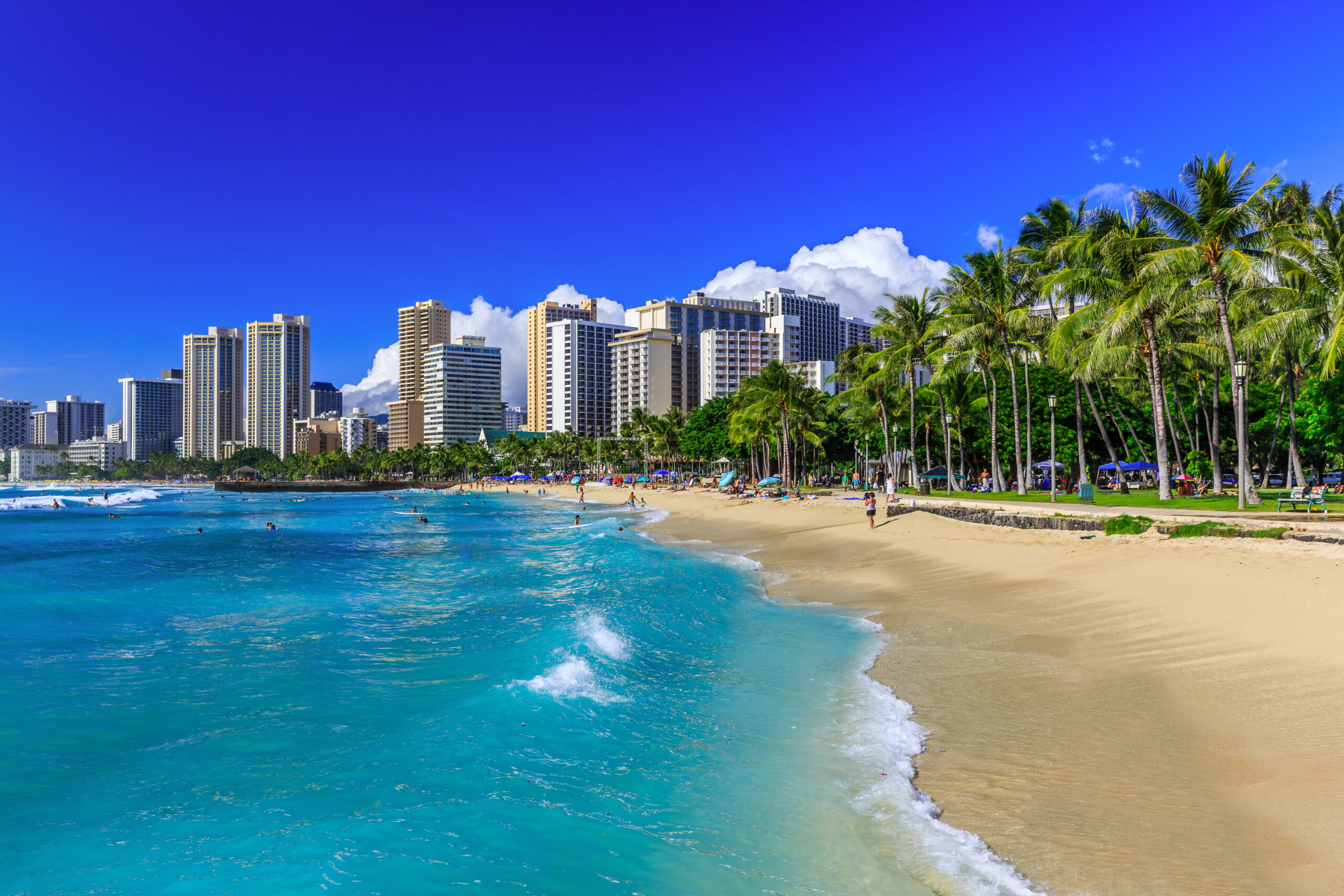 Business class flights round - Honolulu, Hawaii. Waikiki beach and Honolulu's skyline.