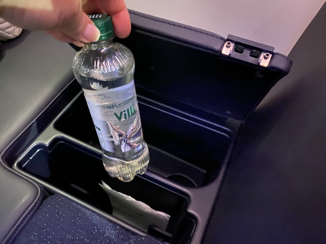 Putting a water bottle inside the storage space of Finnair new A350 business class "AirLounge" non-reclining seats