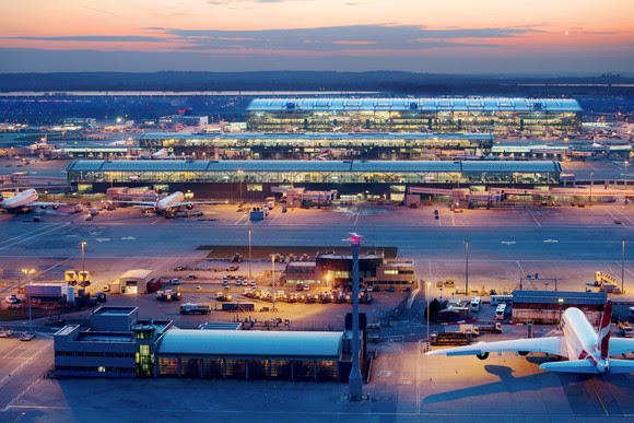 Heathrow Airport, Terminal 5 complex, T5A (top) T5B and T5C (centre), viewed from control tower at dusk, airfield operations base in lower foreground, March 2013.