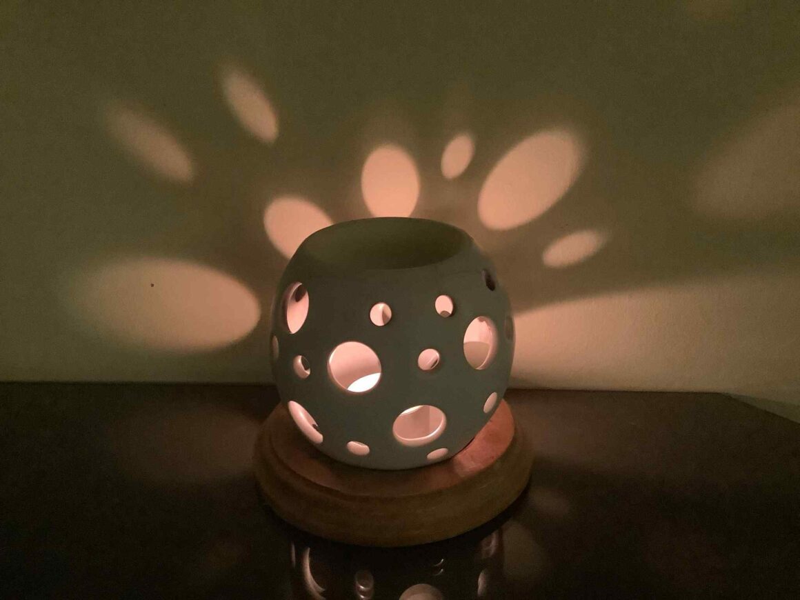 A photo of Night-time oil burner with many holes