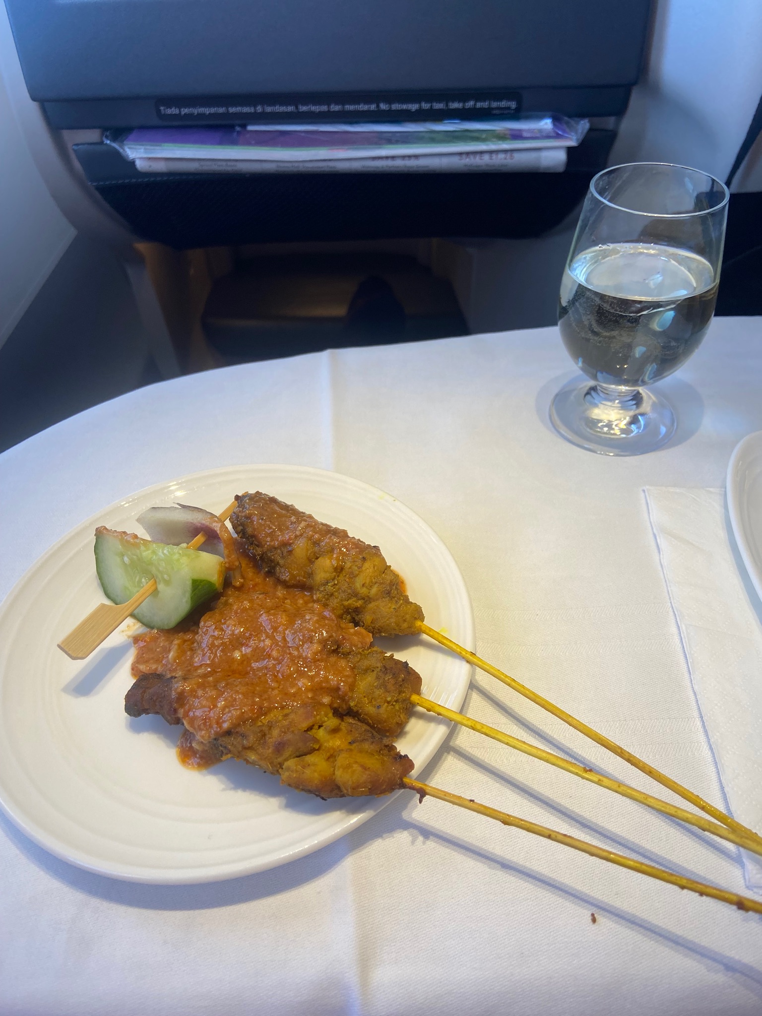 A photo of Malaysia Airlines business class serving a satay